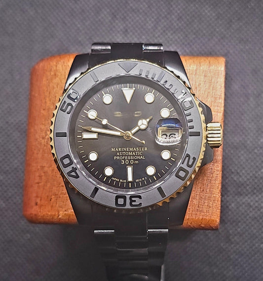 Modded Seiko submariner with a black and Gold dial and oyster or Jubilee bracelet